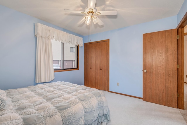 carpeted bedroom featuring a closet and ceiling fan