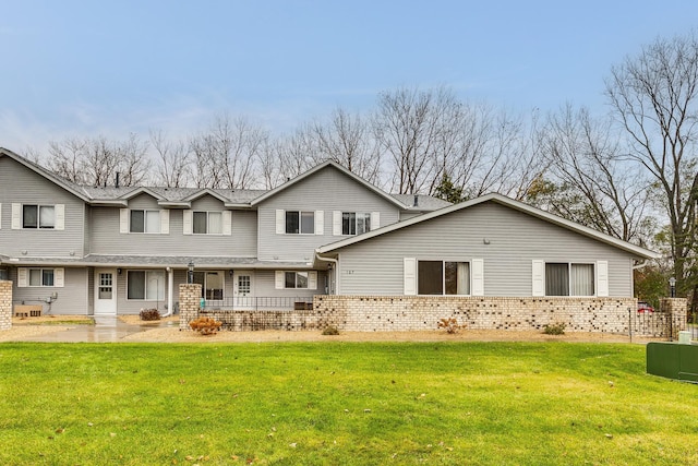 rear view of house featuring a yard