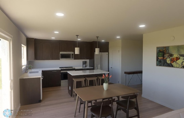 dining room with light hardwood / wood-style flooring and sink