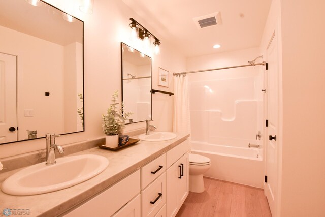 6273 86th Ave S, Horace, ND 58047 - full bath with wood finished floors, toilet, shower / tub combo with curtain, and double vanity