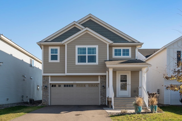 craftsman-style house with a garage and central AC