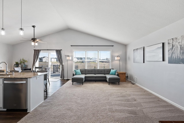 living room featuring ceiling fan, dark hardwood / wood-style floors, sink, and vaulted ceiling