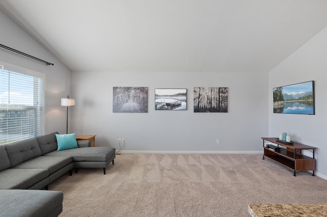 carpeted living room with lofted ceiling