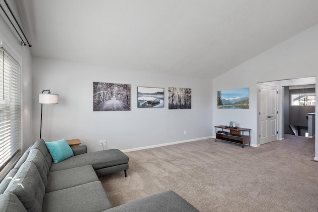 carpeted living room featuring a wealth of natural light and lofted ceiling