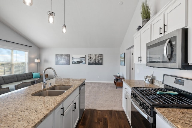 kitchen featuring stainless steel appliances, white cabinetry, sink, and lofted ceiling