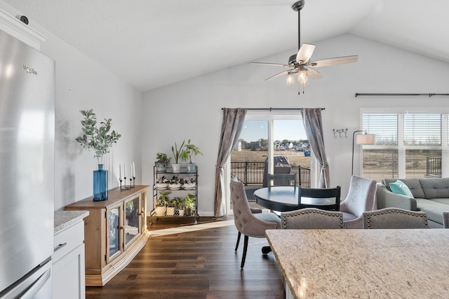 dining space with lofted ceiling, dark wood-type flooring, and ceiling fan