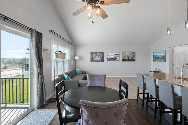 dining area featuring high vaulted ceiling, ceiling fan, and dark hardwood / wood-style floors