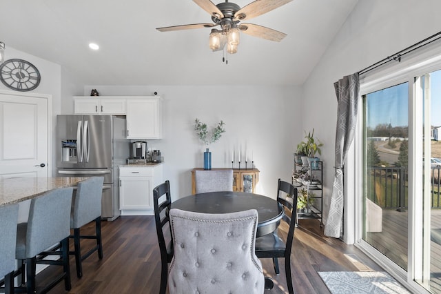 dining area featuring dark hardwood / wood-style flooring, lofted ceiling, and ceiling fan