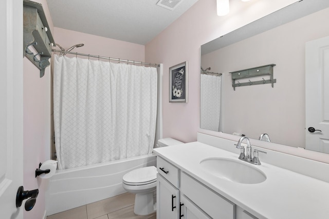 full bathroom featuring vanity, a textured ceiling, shower / tub combo, tile patterned flooring, and toilet