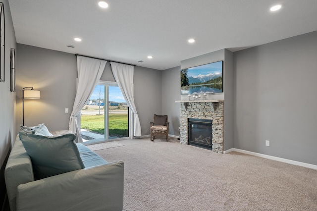 living room with carpet floors and a fireplace