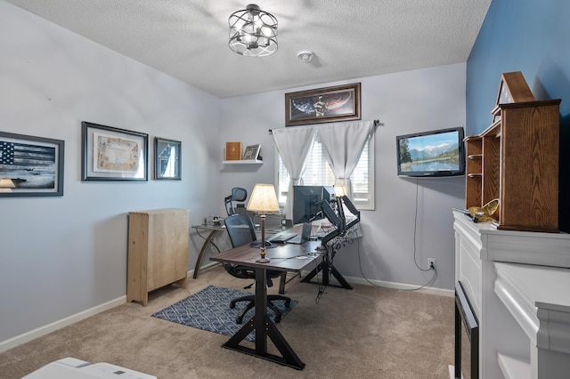 office area with light colored carpet and a textured ceiling