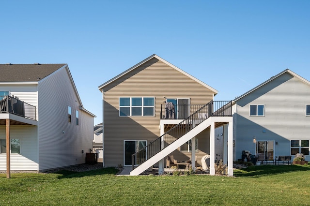 back of house with a lawn and a deck