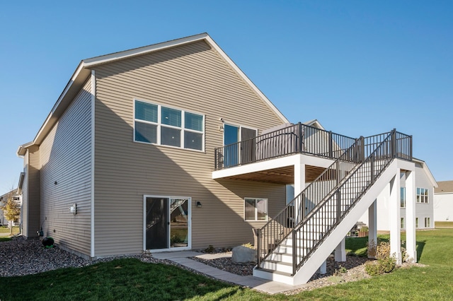 rear view of property with a lawn and a deck