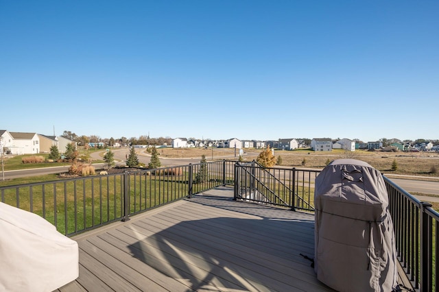 wooden terrace featuring a yard