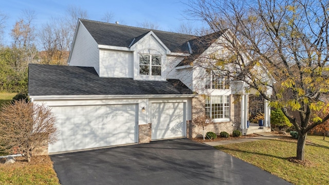 view of front of property with a front lawn and a garage