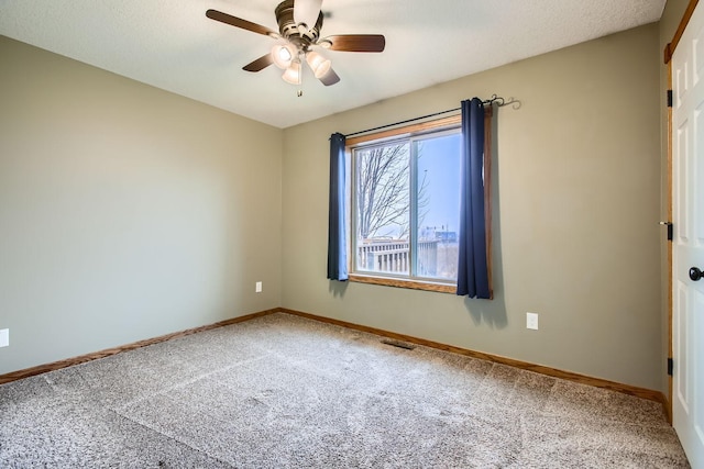 empty room featuring carpet, a textured ceiling, and ceiling fan