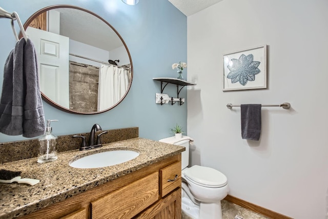 bathroom with vanity, curtained shower, and toilet