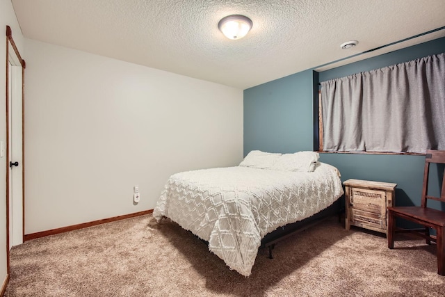 carpeted bedroom featuring a textured ceiling