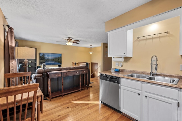 kitchen with dishwasher, light hardwood / wood-style flooring, sink, and white cabinets