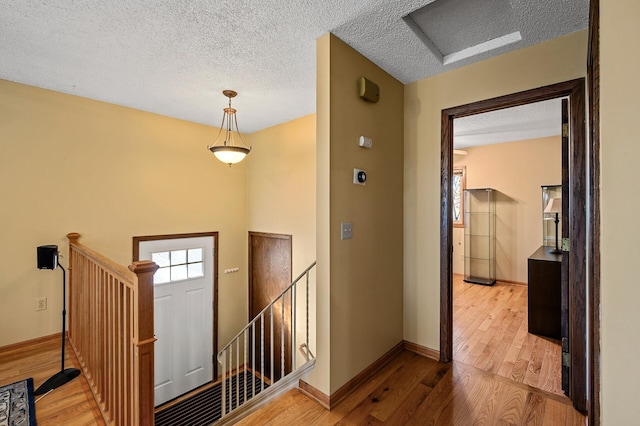 foyer featuring hardwood / wood-style floors and a textured ceiling