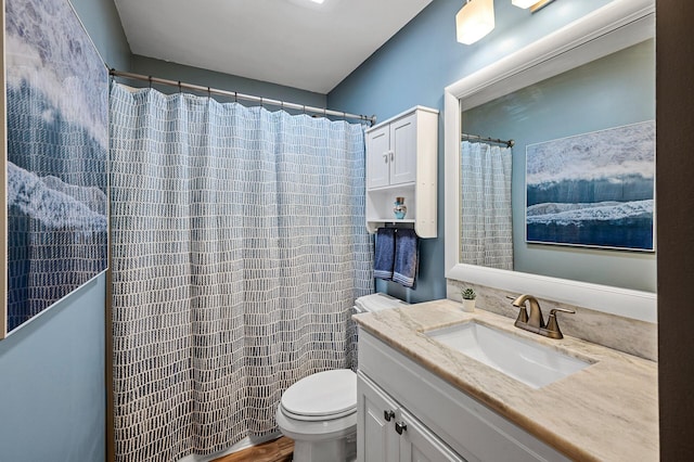 bathroom featuring hardwood / wood-style floors, a shower with shower curtain, vanity, and toilet