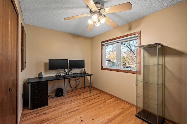 office with light wood-type flooring, a textured ceiling, and ceiling fan