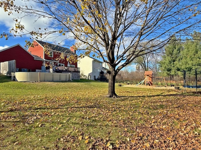 view of yard with a playground and a trampoline