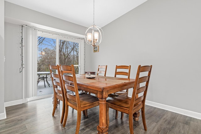 dining area featuring a notable chandelier and dark wood-type flooring