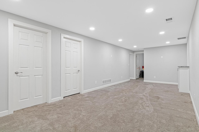 basement featuring light colored carpet