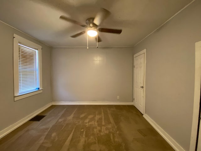 carpeted spare room featuring ceiling fan