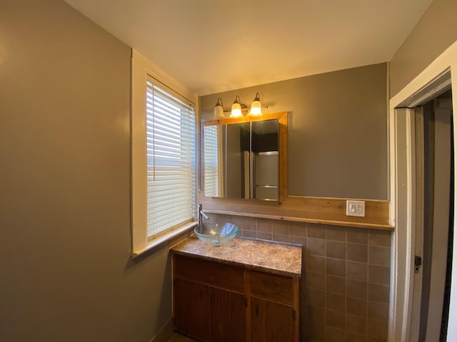 bathroom featuring vanity and tile walls