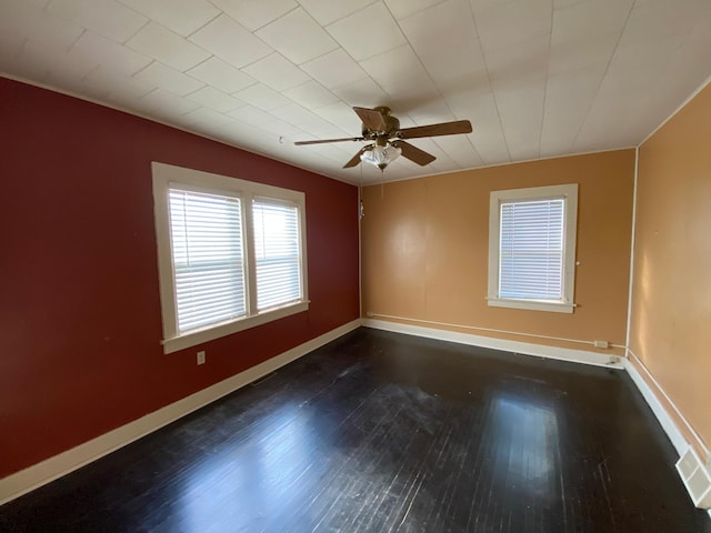 empty room featuring dark hardwood / wood-style flooring and ceiling fan