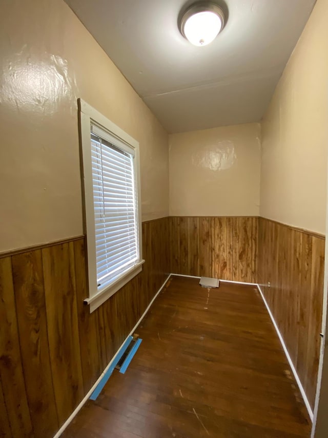 washroom featuring wood walls and dark hardwood / wood-style floors