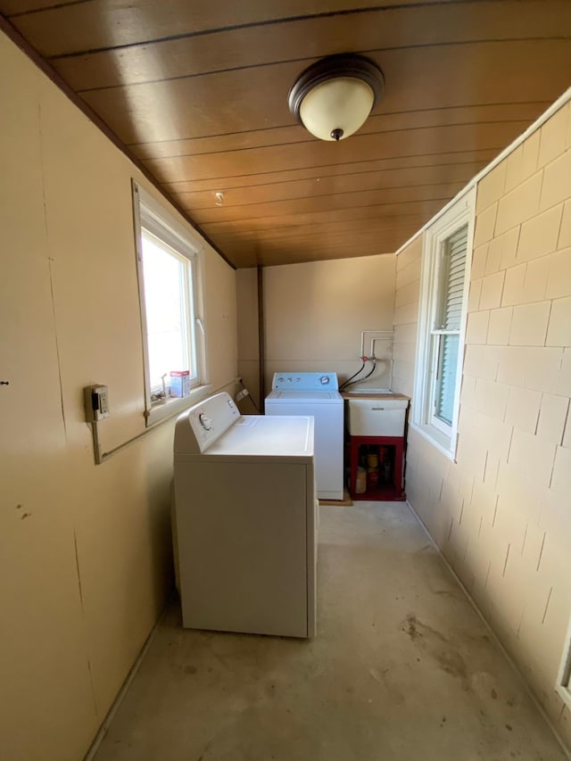 clothes washing area featuring washing machine and clothes dryer and wood ceiling