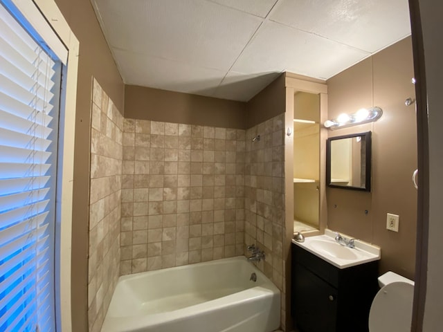 full bathroom with vanity, toilet, and tiled shower / bath combo