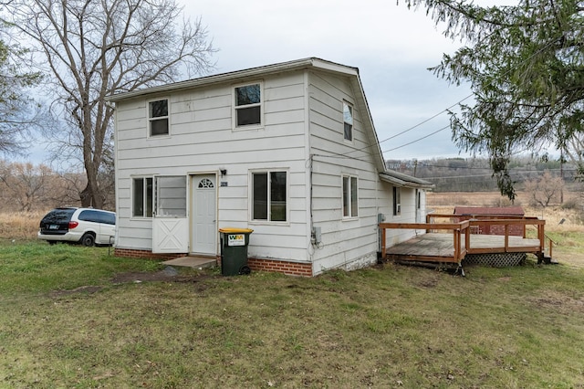 view of front of home featuring a front yard and a deck