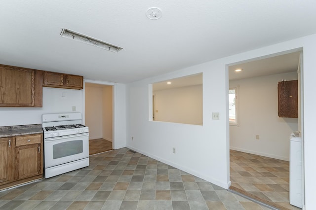 4163 Horseshoe Ct NE, Haverhill Twp, MN 55906 - kitchen with washer / clothes dryer and white gas stove