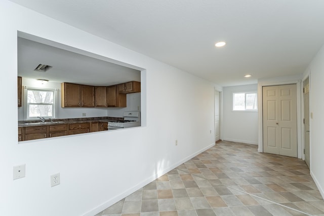 4163 Horseshoe Ct NE, Haverhill Twp, MN 55906 - kitchen featuring white range with gas cooktop, a wealth of natural light, and sink
