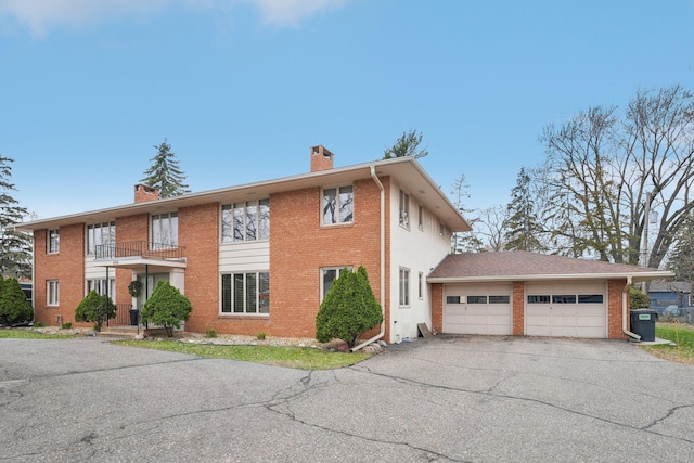 view of front of house with a garage and a balcony