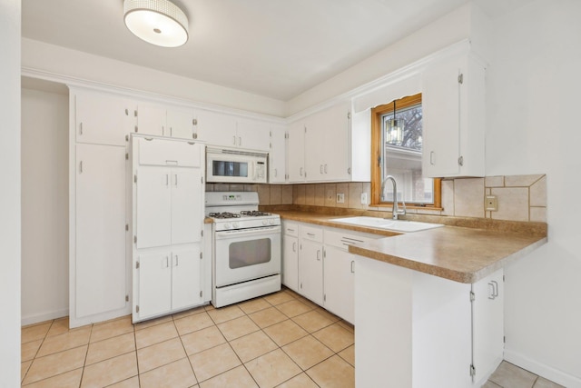 kitchen with tasteful backsplash, white cabinetry, and white appliances