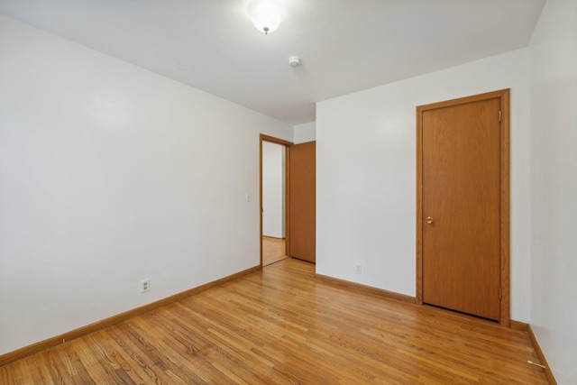 empty room with light hardwood / wood-style flooring