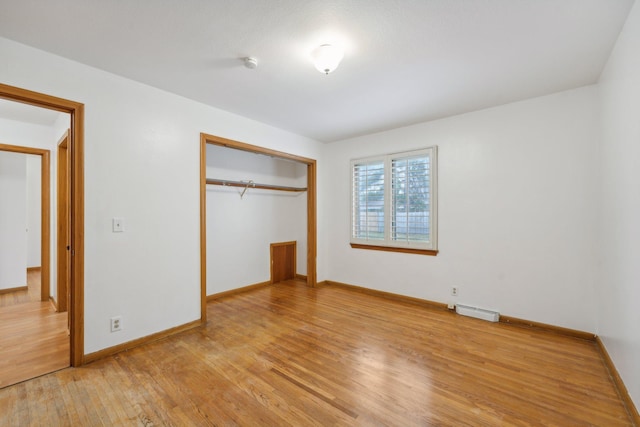 unfurnished bedroom with light hardwood / wood-style floors and a closet