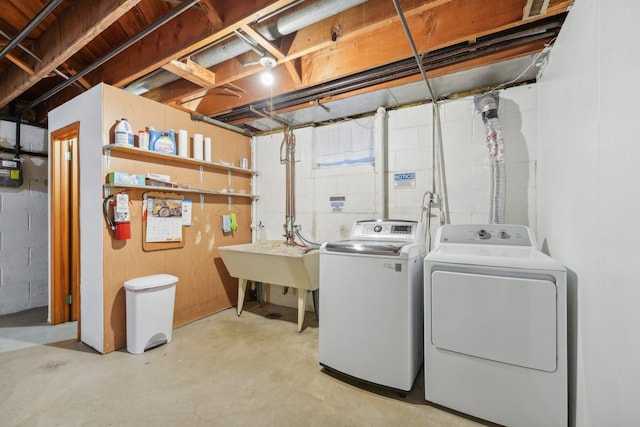 washroom with separate washer and dryer and sink