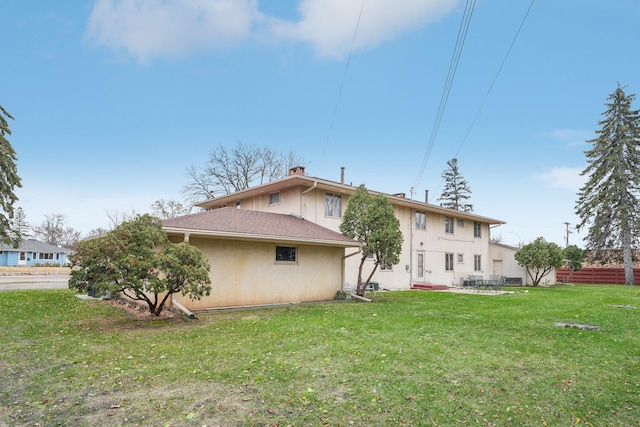 back of house featuring a yard and a patio area