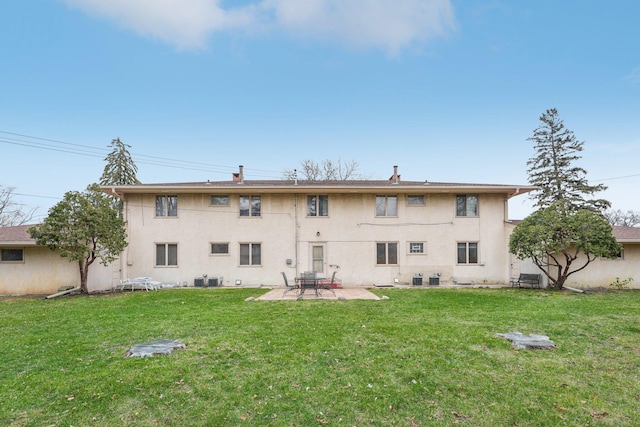 rear view of house featuring a lawn, a patio area, and central air condition unit