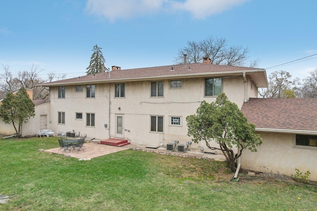 back of property with a patio, central AC unit, and a lawn