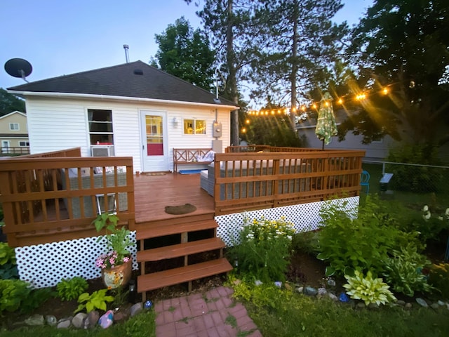 rear view of house with a wooden deck