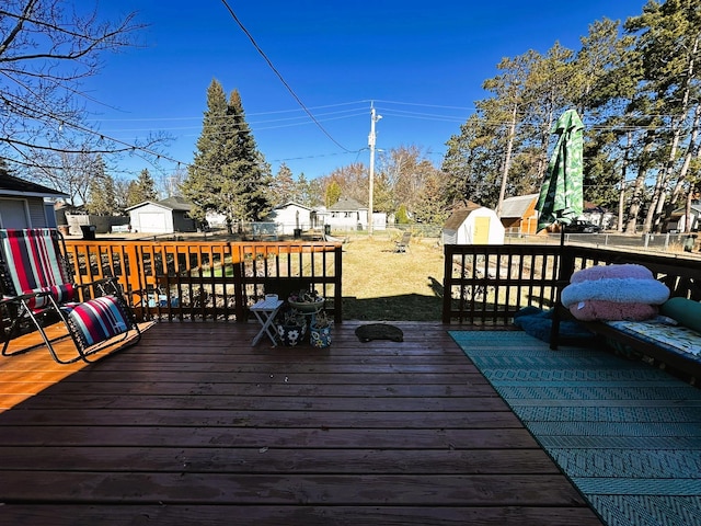 wooden terrace featuring a storage shed