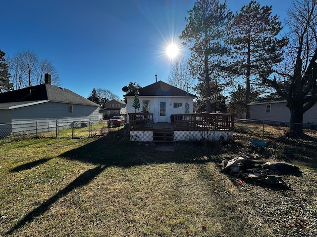 back of house with a yard and a deck