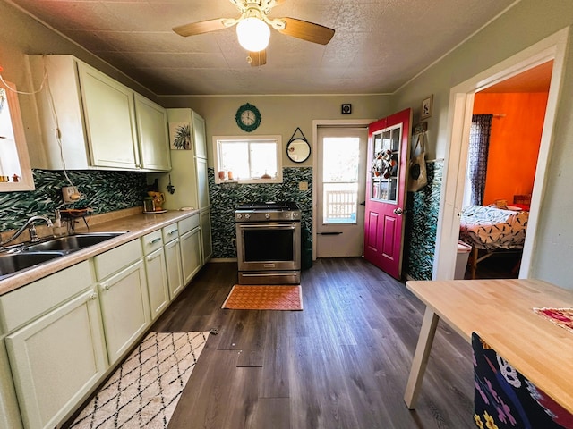 kitchen with dark wood-type flooring, backsplash, sink, high end stainless steel range oven, and ceiling fan